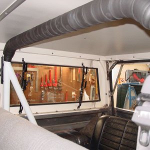 Adjustable seat belt mounting points on a roll bar